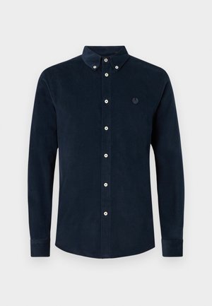 Mörk marinblå kordfläks långärmad skjorta med knäppning, knäppkrage och en liten broderad logotyp på vänster bröst.