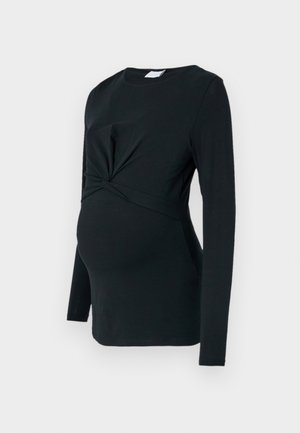 Blusa de maternidad negra de manga larga con detalle frontal retorcido, hecha de una tela suave, con forma ajustada y escote redondo.