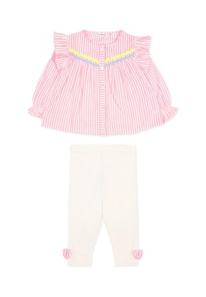 Roze-wit gestreepte blouse met lange mouwen, ruches en een geel-blauwe rand, gecombineerd met witte leggings met roze gestreepte strikjes bij de enkels.