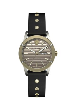 Versace watch with a round gold-tone case, gray striped dial, black rubber strap, gold dot accents, and date display at the 3 o’clock position.