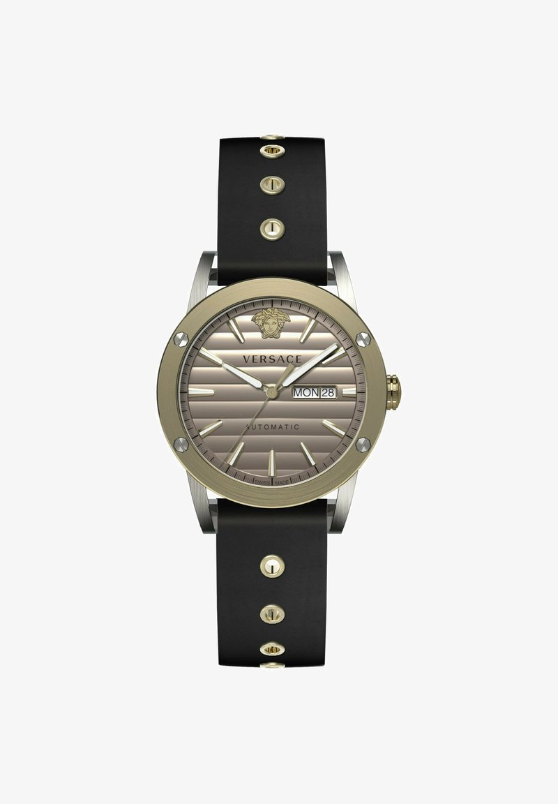 Versace watch with a round gold-tone case, gray striped dial, black rubber strap, gold dot accents, and date display at the 3 o’clock position.