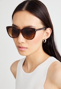 COACH Slnečné okuliare - tortoise/transparent beige