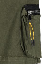 Olive green fabric with a side pocket featuring a black zipper and yellow drawstring accents. The pocket has a fold for added depth.