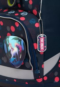 Marineblauer Rucksack mit mehrfarbigem Punktdesign, ausgestattet mit einer Einhorn-Illustration, einem Reißverschluss und einem angehängten Namensschild zur Personalisierung.