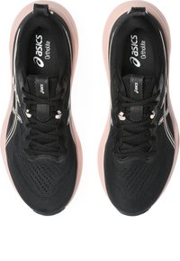 Black athletic shoes with a breathable mesh upper, pink rubber sole, and metallic silver accents. Ortholite cushioning logo visible.