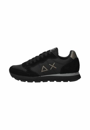Schwarzer Sneaker mit niedrigem Schaft und Wildleder- sowie Stoffeinsätzen, mit Dreiecks- und Kreuzsymbolen an der Seite und einer dicken Gummisohle.