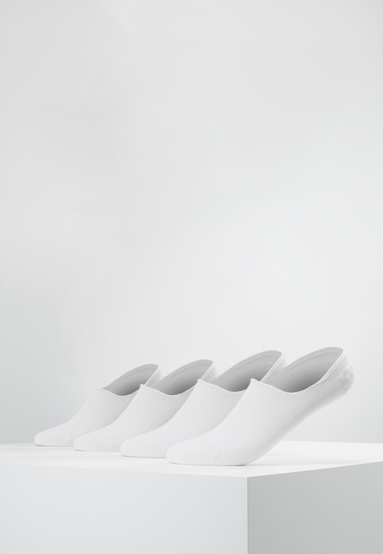 White slip-on socks displayed on a white pedestal. The fabric has a smooth texture with a ribbed pattern along the sides.