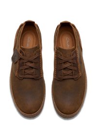 Scarpe in pelle marrone con punta arrotondata, finitura testurizzata e lacci coordinati. Presentano cuciture visibili e un'etichetta con il marchio sul lato.