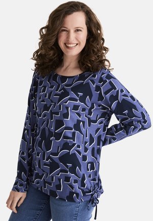 Langärmliges Oberteil in Marineblau mit abstraktem geometrischen Muster in Blau und Weiß. Mit Rundhalsausschnitt und Kordelzügen am Saum.