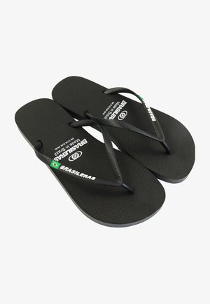 Chanclas de goma negras con suelas texturizadas y correas negras. Presentan "BRASILERAS" y el logo de la marca impresos en blanco en la planta.