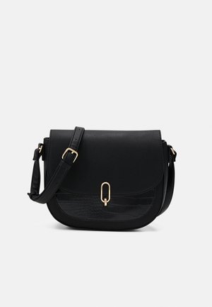 Sac bandoulière en cuir noir avec sangle réglable, boucle dorée et détail texturé sur la poche avant sur fond blanc uni.