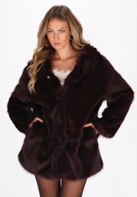 Burgundy faux fur coat with long sleeves, a v-neckline, and a button closure. Features a soft texture and side pockets.