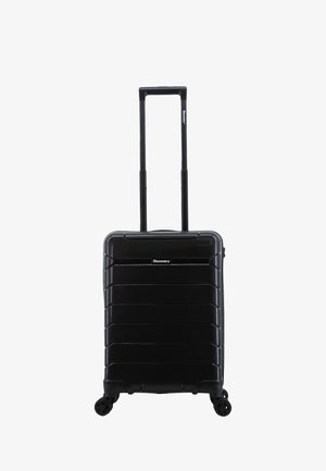 Black hard-shell suitcase with a ribbed design, extendable handle, and four wheels for mobility. Accented with a brand logo on the front.
