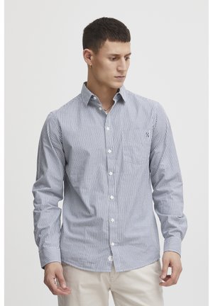 Striped button-up shirt with narrow navy and white stripes, long sleeves, single chest pocket, and a standard collar. Cotton fabric.
