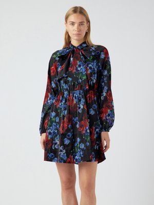Black floral dress with red and blue flower patterns, long puff sleeves, a bow tie at the neck, and an elasticized waistline.