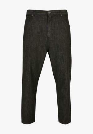 Čierne denimo nohavice s uvoľneným strihom, vybavené zipsom, pútkom na opasok a piatimi vreckami. Tkanina má jemnú štruktúru.