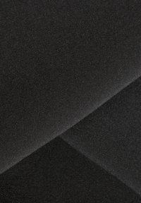 Två överlappande bitar av svart tyg med fin struktur och synligt vävmönster, visat i närbild.