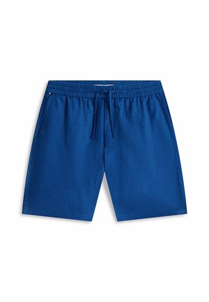 Blaue Freizeithose mit elastischem Bund und Kordelzug, mit Seitentaschen und kleinem dreifarbigen Flaggen-Detail nahe der Taille.