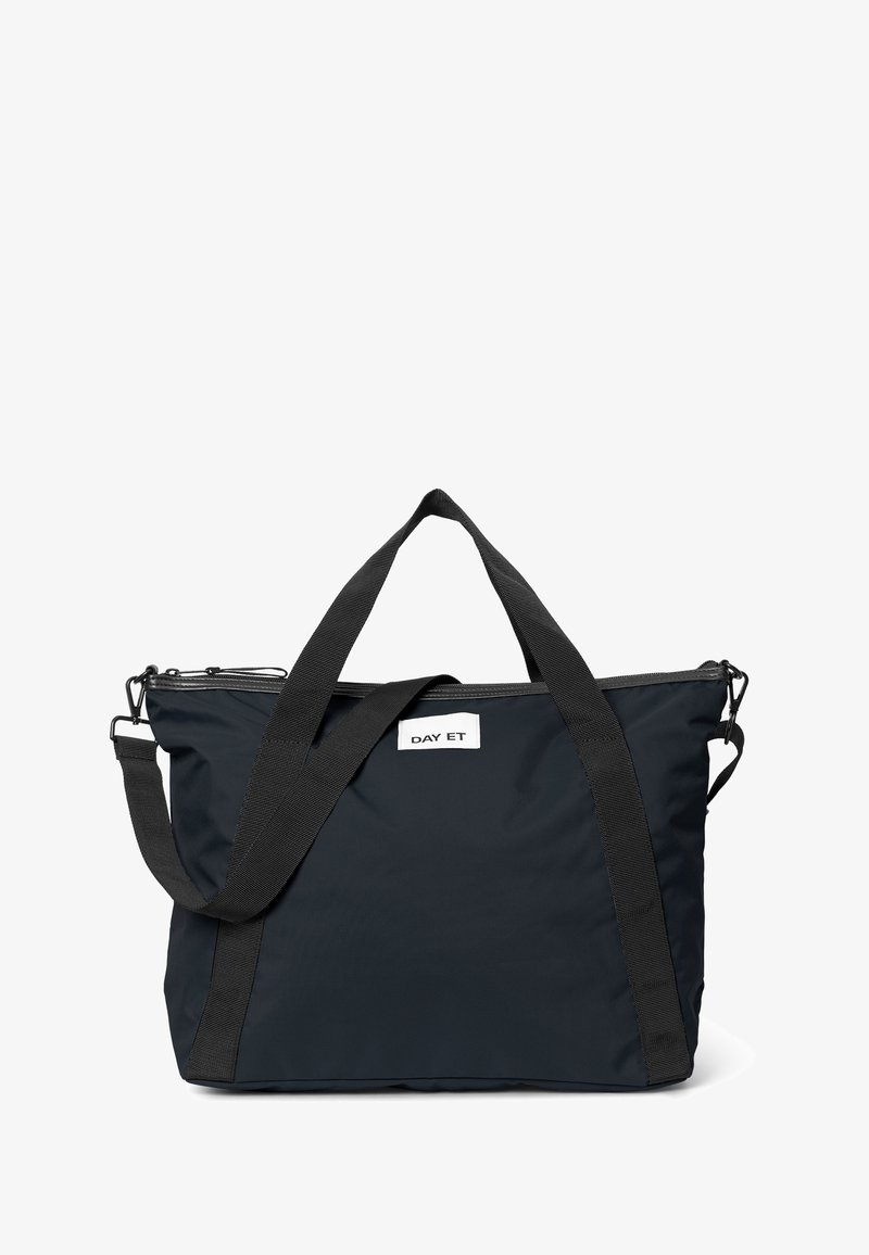 Dunkelblaue Tasche mit zwei stabilen schwarzen Trägern und einem Reißverschluss oben. Das Markenlabel "DAY ET" ist auf der Vorderseite sichtbar.
