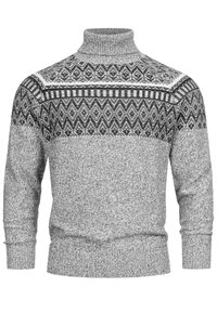Grauer Strickpullover mit hohem Kragen, der ein geometrisches Schwarz-Weiß-Muster über der Brust aufweist, sowie gerippte Bündchen und einen gerippten Saum.