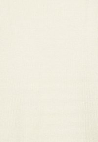 Krämfärgad stickad tröja med mjuk textur, räfflade detaljer och en enkel, sömlös design. Lämplig för lager-på-lager eller avslappnad stil.