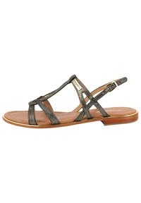 Metalen bronzen platte sandalen met een crisscross ontwerp, voorzien van smalle banden en een gesp-sluiting, op een lichtbruine zool.