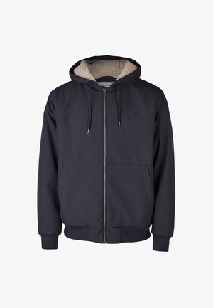 Navy zip-up hoodie with a plush cream fleece-lined hood, front pockets, and subtle logo embroidery; made from soft, textured fabric.