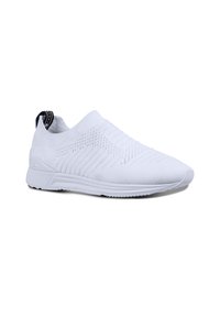 White slip-on athletic shoes with a textured knit upper and smooth rubber sole, featuring a black and white tab at the heel.