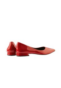 Red patent leather ballet flats with a pointed toe and a low, rectangular heel. Smooth texture, minimalist design, and no visible hardware.