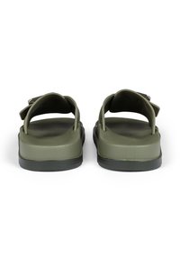 Green rubber sandals with open back and adjustable strap design. Textured footbed and solid black outsole for stability.