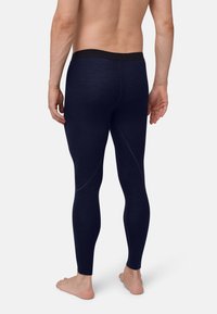 Navyblaue, enganliegende Leggings aus weichem, dehnbarem Stoff. Mit einem schwarzen elastischen Taillenbund und subtilen Nahtdetails entlang der Beine.