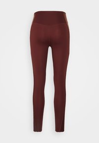 Leggings bordeaux realizzati in tessuto elasticizzato con vita alta, dotati di pannelli laterali senza cuciture e una texture liscia.
