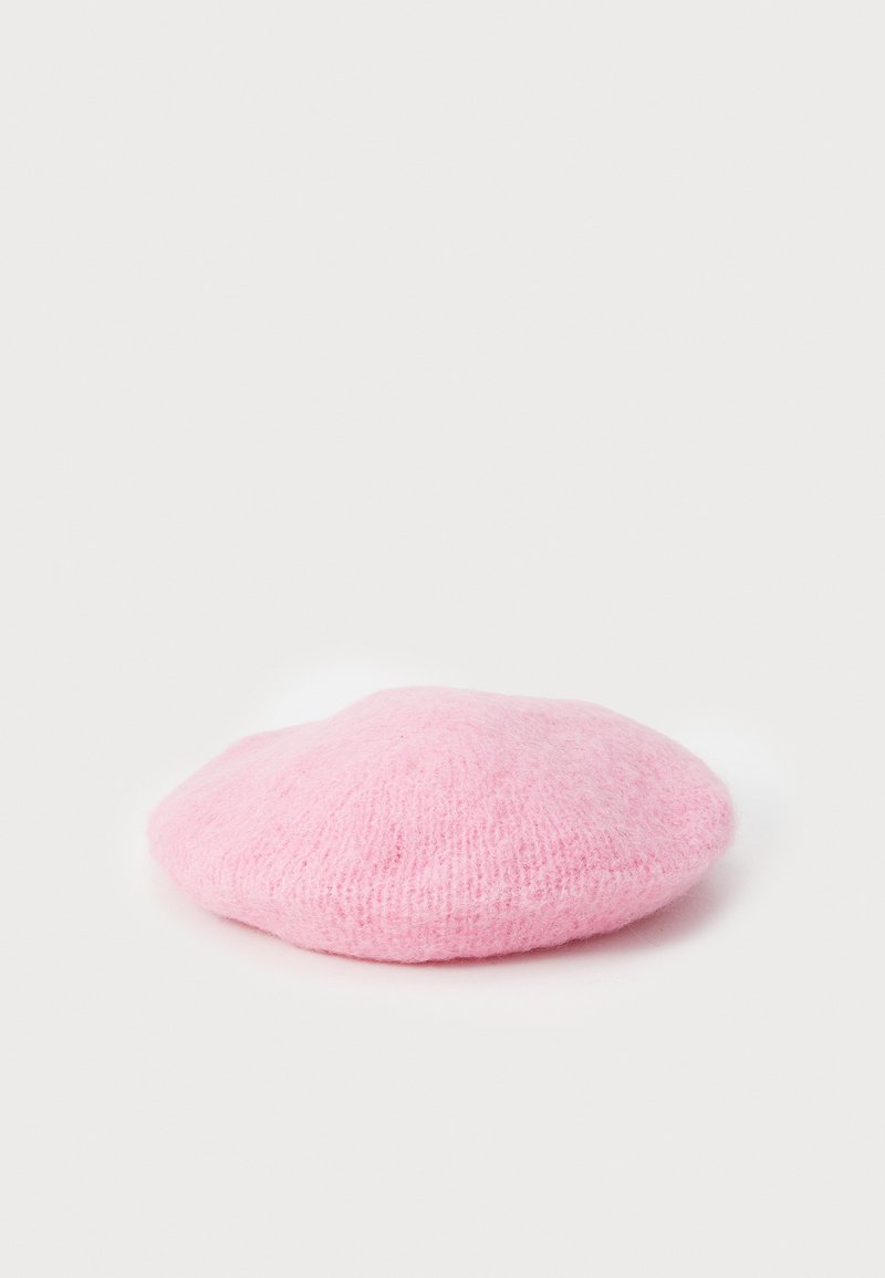 Rosa uldeberet med en blød tekstur, rund form og en let hævet midte. Minimalistisk design uden synligt hardware eller accenter.