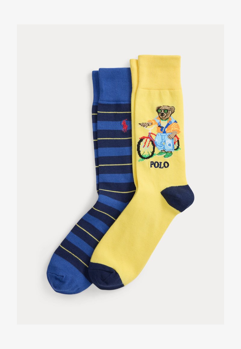 One pair of socks with blue and navy stripes and red logo, one yellow sock with bear on bicycle wearing sunglasses and "POLO" text.