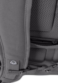 Gray backpack with a textured fabric, padded sections, mesh ventilation, and multiple zippers. Features branded logo and adjustable straps.