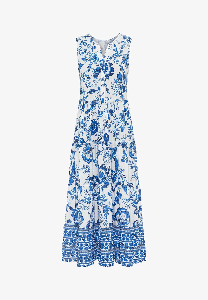 Robe longue blanche sans manches avec motifs floraux et feuillages bleus, col en V avec boutons et jupe à volants avec ourlet à motifs.