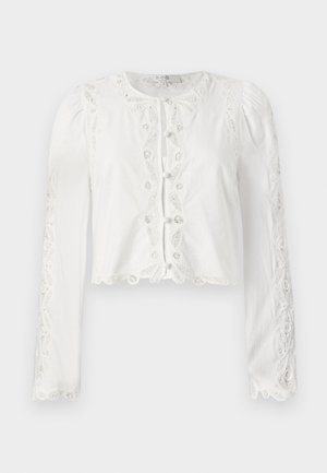 Bílá zkrácená blůza s dlouhými rukávy, krajkovými detaily a knoflíkovým zapínáním vpředu. Texturovaná látka se zvlněným lemem a výšivkovými akcenty.