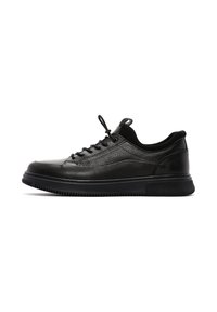 Black leather sneakers with textured upper, round toe, lace closure, and cushioned sole. Features a smooth black rubber outsole.