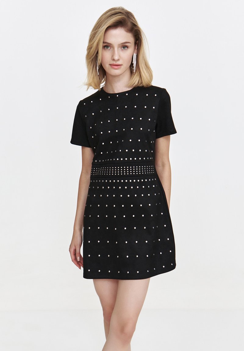 Black short-sleeve dress made of soft fabric, featuring silver metallic studs and a fitted waist. The skirt has a slightly flared cut.