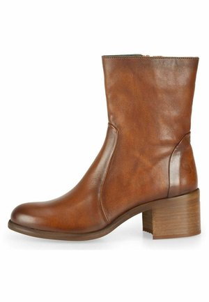 Brown leather ankle boot with a rounded toe, smooth finish, and a mid-height block heel. Zipper closure on the inner side for easy wear.
