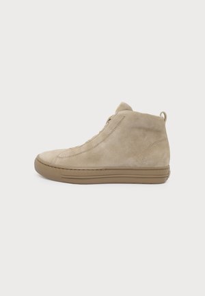Tan suede ankle boot with a brown rubber sole, minimal stitching, no visible laces, side view, set against a plain white background.