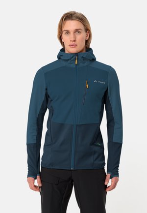 Giacca con cappuccio da uomo, blu scuro, tessuto leggero, pannello frontale trapuntato, tasche con zip, polsini elasticizzati, orlo regolabile, branding minimale.