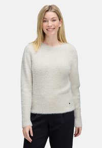 Helle beige Strickjacke aus strukturiertem, flauschigem Material mit geripptem Saum und Bündchen. Crew-Neck-Design mit minimaler Detailgestaltung.