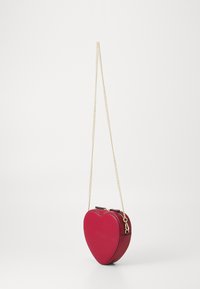 Red heart-shaped handbag made of smooth leather, featuring a gold chain strap and a secure zipper closure at the top.