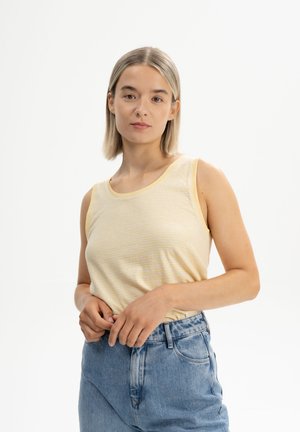 Yellow and white striped sleeveless top with a round neckline, paired with high-waisted blue denim jeans. Simple, casual design.