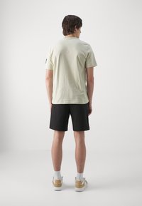 Calvin Klein Jeans LOGO REPEAT - Pantalones deportivos - black