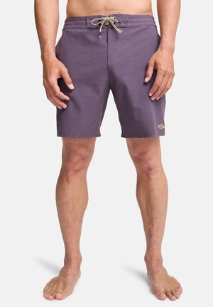 Purple swim shorts with a textured finish, elastic waistband, and a drawstring. Features a small logo patch on the lower leg.