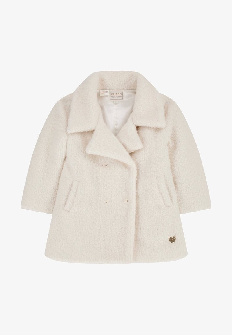 Doppelreihiger, cremefarbener Mantel aus strukturiertem Stoff mit weichem Finish. Verfügt über zwei Vordertaschen und einen Logoakzent in der Nähe des Saums.