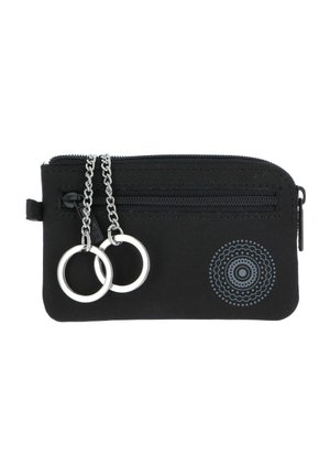 Black zippered pouch with two silver key rings attached by short chains, and a circular dotted pattern on the lower right corner.
