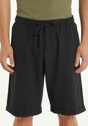 Schwarze Shorts mit elastischem Bund, verstellbarem Kordelzug und umgeschlagenen Säumen. Hergestellt aus strukturiertem Stoff für Komfort und eine bessere Passform.